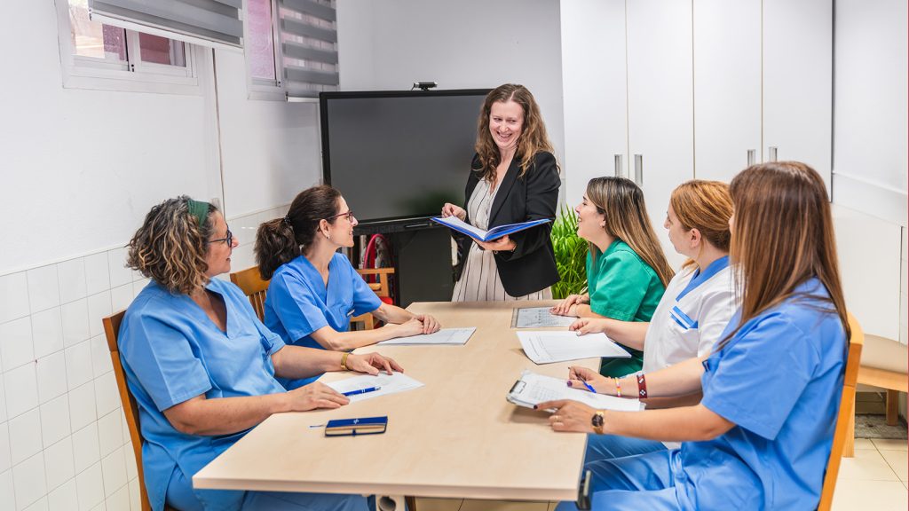 Nurses engaging in team meeting at nursing home