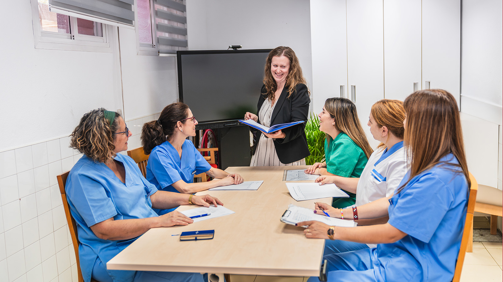Nurses engaging in team meeting at nursing home