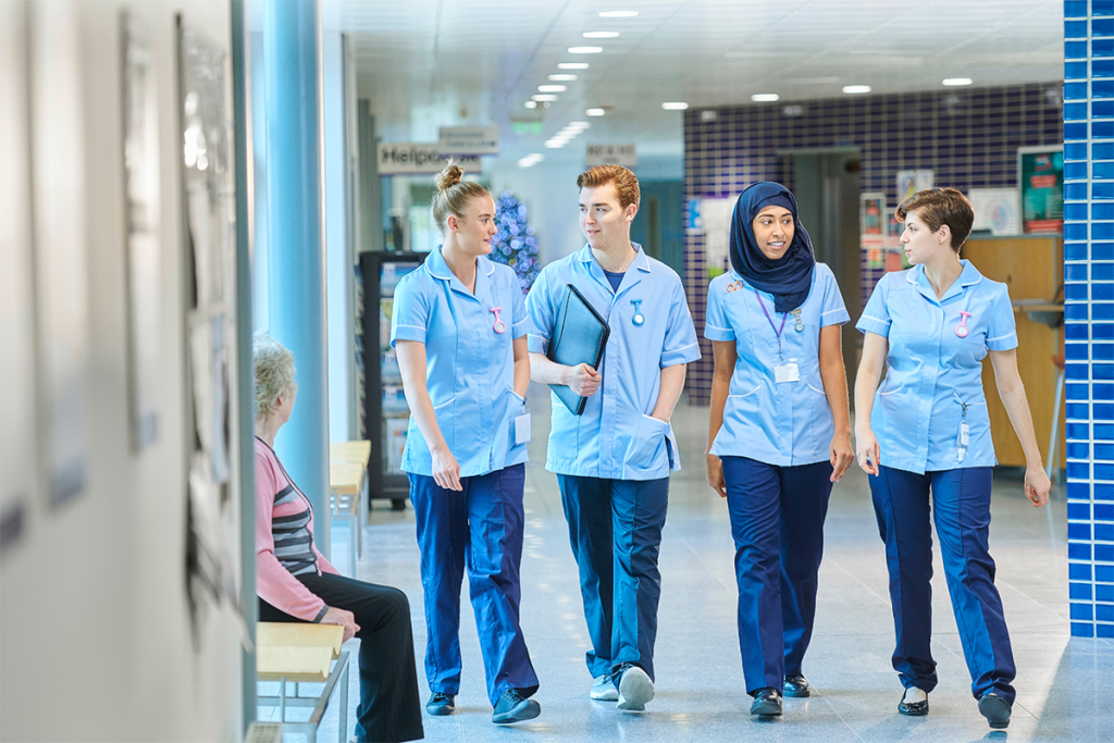 Four nurses in hospital walking together